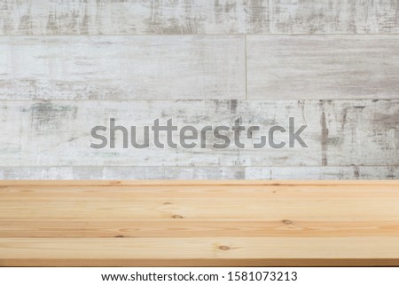 Wooden board empty table in front of a blurred background. Perspective brown wood with blurry grunge or old wall backdrop - can be used to showcase or mount your products. Mock up 