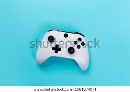Joystick gaming controller isolated on blue background , Video game console developed Interactive Entertainment