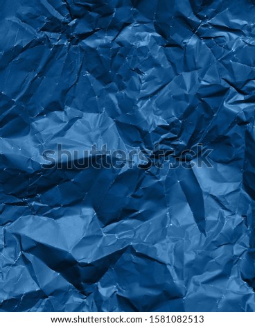 Photo of crumpled paper texture in trendy blue color.Color of the Year 2020.