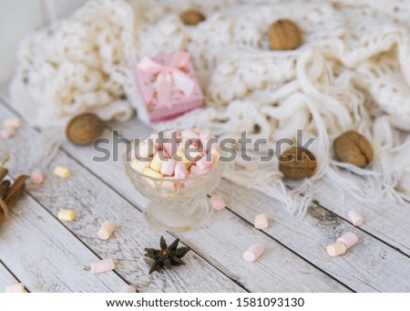 A lot of marshmallow, sweater, cinnamon, presents . Cozy christmas composition.Winter time. Christmas holiday concept.