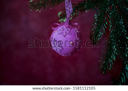 Christmas tree toy of handwork. Beautiful sparkling bokeh. christmas fir tree decoration on glitter background. Happy New Year's card. Christmas ball with Christmas sparks in dark.