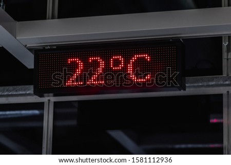 Electronic scoreboard at the airport, which shows a temperature of 22 degrees Celsius