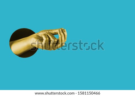 Hand painted in gold shows different gestures and symbols from the hole on a bright blue paper background. Creative template for design. 
