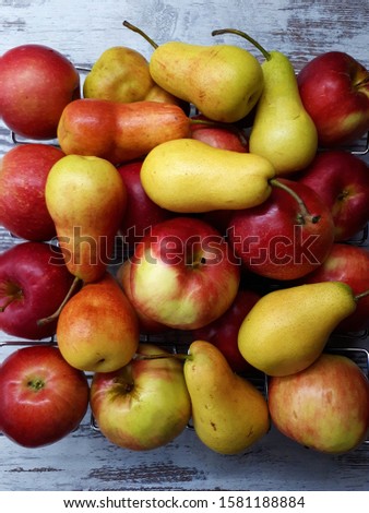 
close-up of apples and pears on a wooden surface