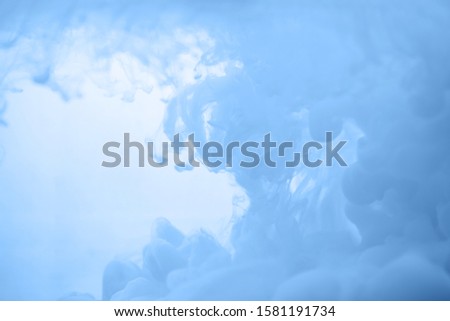 Ink in water in a classic blue color. Look like a cloud or smoke or without gravity.