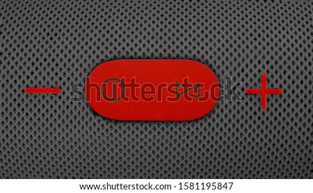 Wireless music column. Red control and volume buttons on gray speaker. Wallpaper and background.