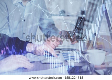 Multi exposure of chart with man typing on computer in office on background. Concept of hard work.