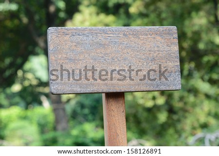 Wooden signboard on grass