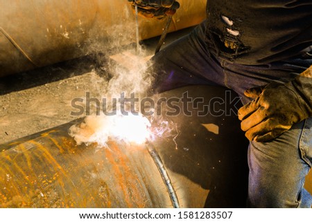 technician combining energy pipe with welding
