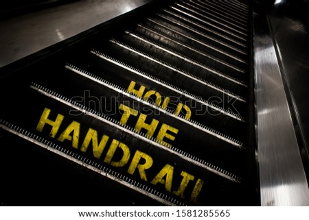Hold the Handrail sign on a escalator 