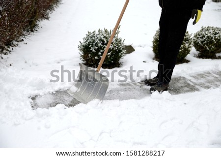 Removing snow from the sidewalk