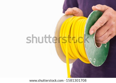 Studio cut out of electrician with cable reel on white background