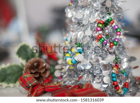 Macro closeup of tinsel and a variety of vibrant yuletide seasonal,decorative objects.