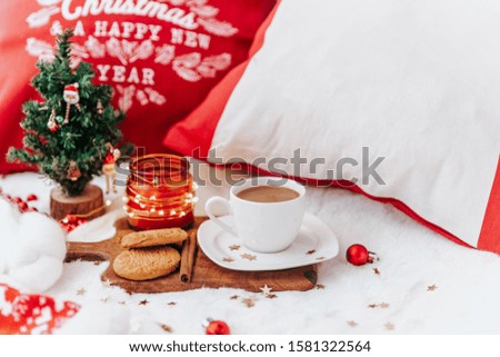 Winter composition with coffee on white bed. Festive cozy concept. 