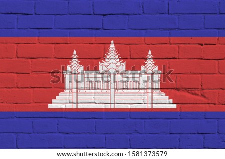 Cambodia flag depicted in paint colors on old brick wall. Textured banner on big brick wall masonry background