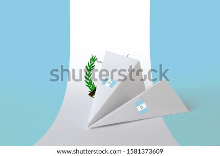 Guatemala flag depicted on paper origami airplane. Handmade arts concept