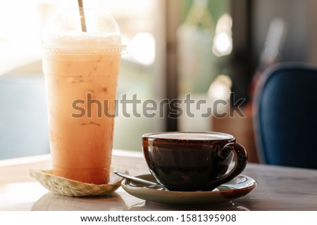 Hot latte coffee with iced Thai tea on the table