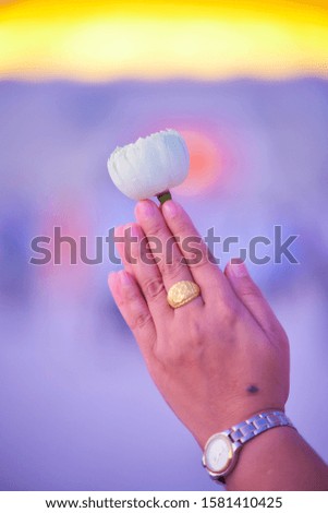 Phanom hand-held lotus blossom worshiping Buddha amulets.