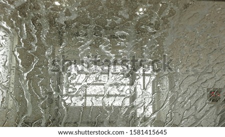 Close up of soap and water on the windshield in a carwash 