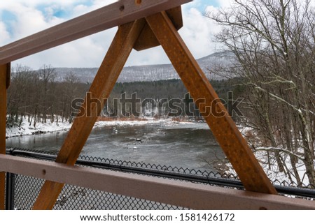 Newly opened Boiceville Bridge on the Ashokan Rail Trail in the Hudson Valley of New York. Sun, clouds and snow. Open for hiking, cross country skiing and snowshoeing and winter activities.