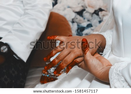 Malaysian wedding ring on finger ceremony