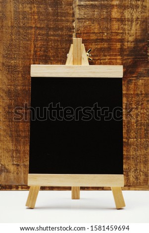 Space wooden easel on wooden background