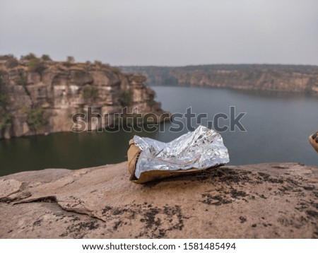 A picture of left waste as food paper or food wrapper on a picnic spot 