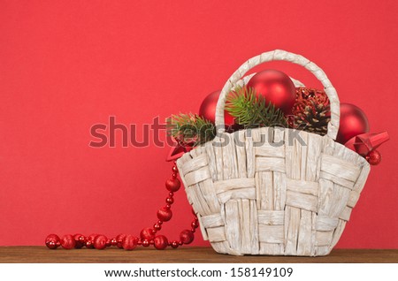 Beautiful Christmas Gift Basket on red background 