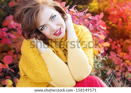 Pretty woman in autumn park