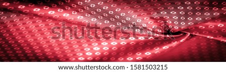 Background texture,  ruby red color of the fabric is thin, strong, soft, shiny fiber obtained by silkworms in the manufacture of cocoons and assembled for the manufacture of threads and fabrics.