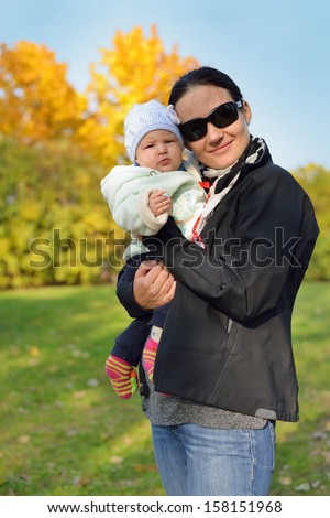Mother with her baby in autumn scenery. MANY OTHER PHOTOS FROM THIS SERIES IN MY PORTFOLIO.