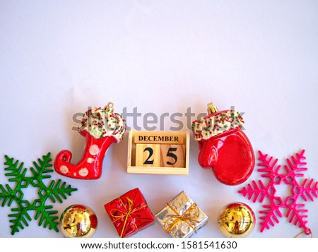 Christmas decoration gift box ,gold balls ,star and December 25 on white background or wallpaper ,free copy space for letter
