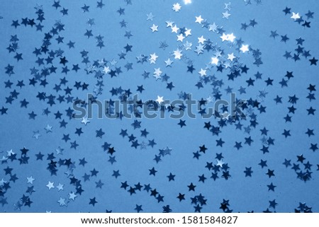 Abstract glowing stars background in classic blue color.