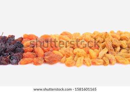 Yellow and Black raisins scattered isolated on white background