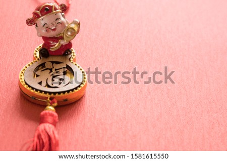  chinese God of fortune and Chinese knot of luck and Chinese gold ingots (foreign meaning blessing, prosperity, fortune)and Red envelopes and decoration with Fresh oranges on Red Paper background