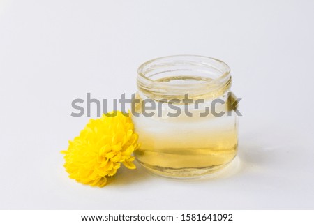 bottle with essential oil and fresh flowers isolated on white background