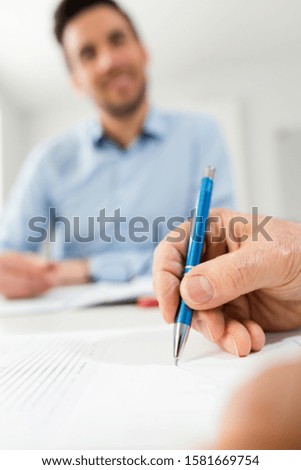two business partners signing a document