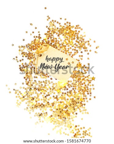 Happy New year greeting card. tag and Golden glitter star confetti on white background. winter holiday concept. top view