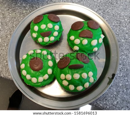 Some green cute monster cupcakes. 