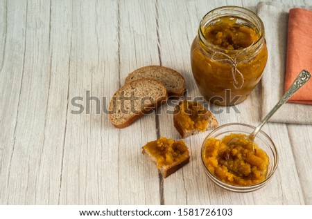 Indian cuisine, popular in England. Chutney is made from apples, raisins and spices. Can of chutney, wholegrain bread. Free space for your text.