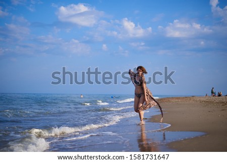woman by the sea in a leopard print dress