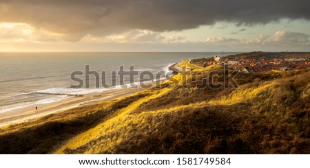 Beautiful evening light, sunset, at the Dutch seaside town of Zoutelande, Westerschelde coastline, copy space Royalty-Free Stock Photo #1581749584