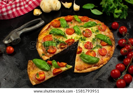 Keto Tortilla Pizza with Shredded Mozzarella, Sliced Cherry Tomatoes and Basil