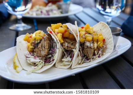 Fish with pineapple and tacos