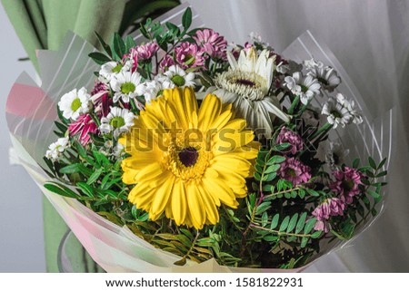 Bouquet of flowers with yellow gerbera in the center.