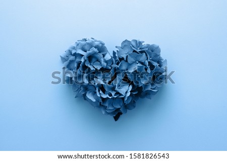 Classic blue Valentine's heart shape made of flowers. Flat lay. Color Year 2020, Love concept.
