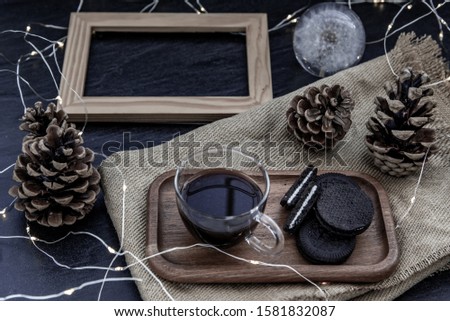 Cup of coffee with chocolate chip cookies on wooden tray. Concept for a tasty snack, Selective focus, Oblique view from the top.