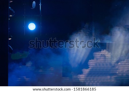 Lighting and spotlights, stage light and smoke in the theater above the stage. Texture background for design.