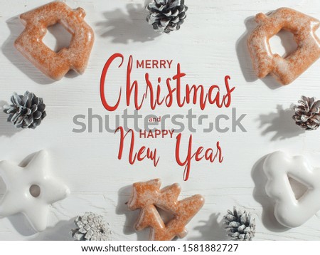 Christmas gingerbread cookies and pine cones on white background, copy space.