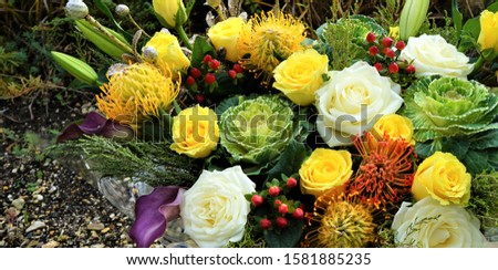 A beautiful picture of many flowers and vegetables in a basket